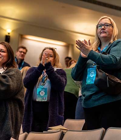 IMPACT conference attendees giving a standing ovation.