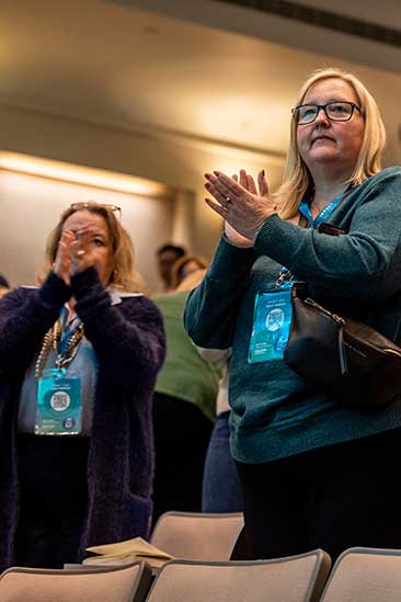 IMPACT conference attendees giving a standing ovation.